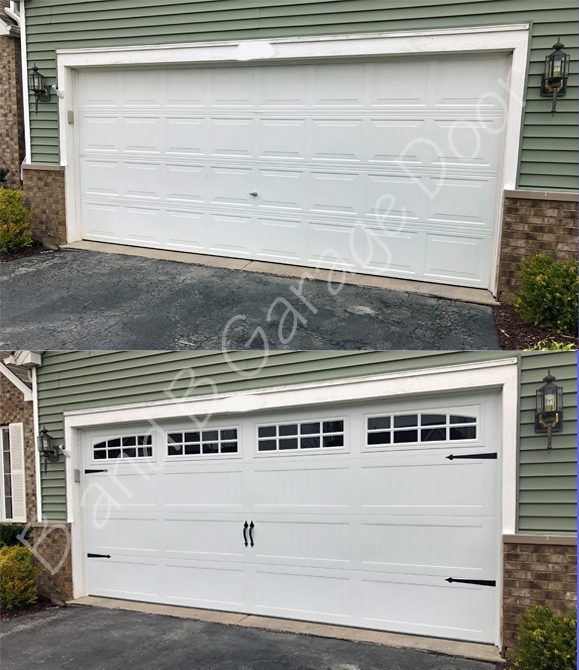 A white carriage-style garage door with decorative black hardware on a nice home.